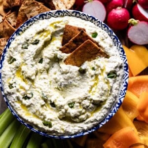 Cava Copycat Crazy feta in a bowl served with pita chips and vegetables.