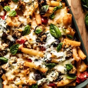 A baked pasta dish garnished with basil from the top view.