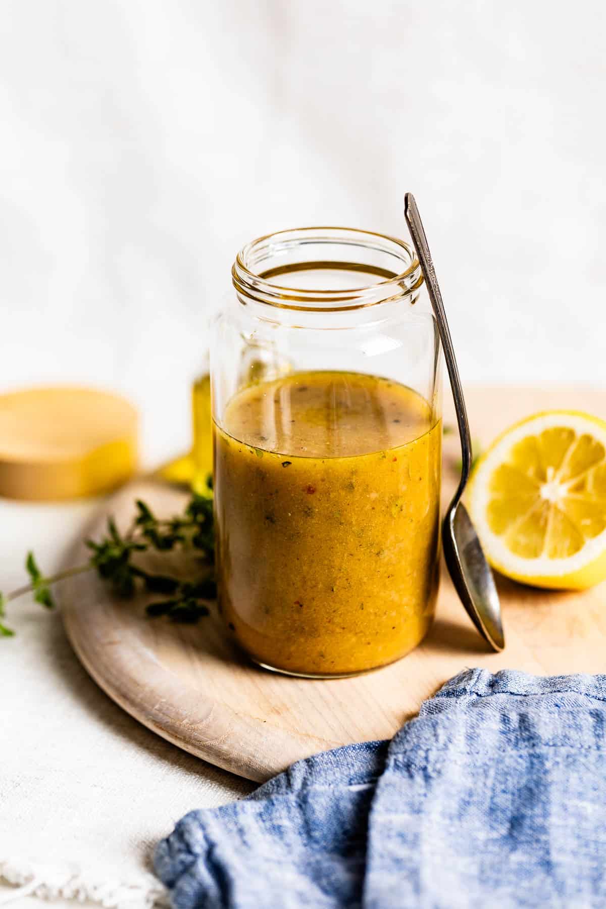 Red wine vinaigrette in a jar with a spoon on the side.