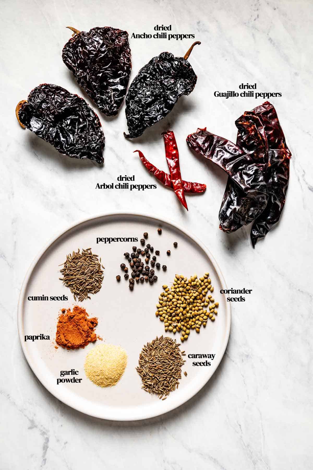 Harissa powder ingredients on a marble backdrop from the top view.