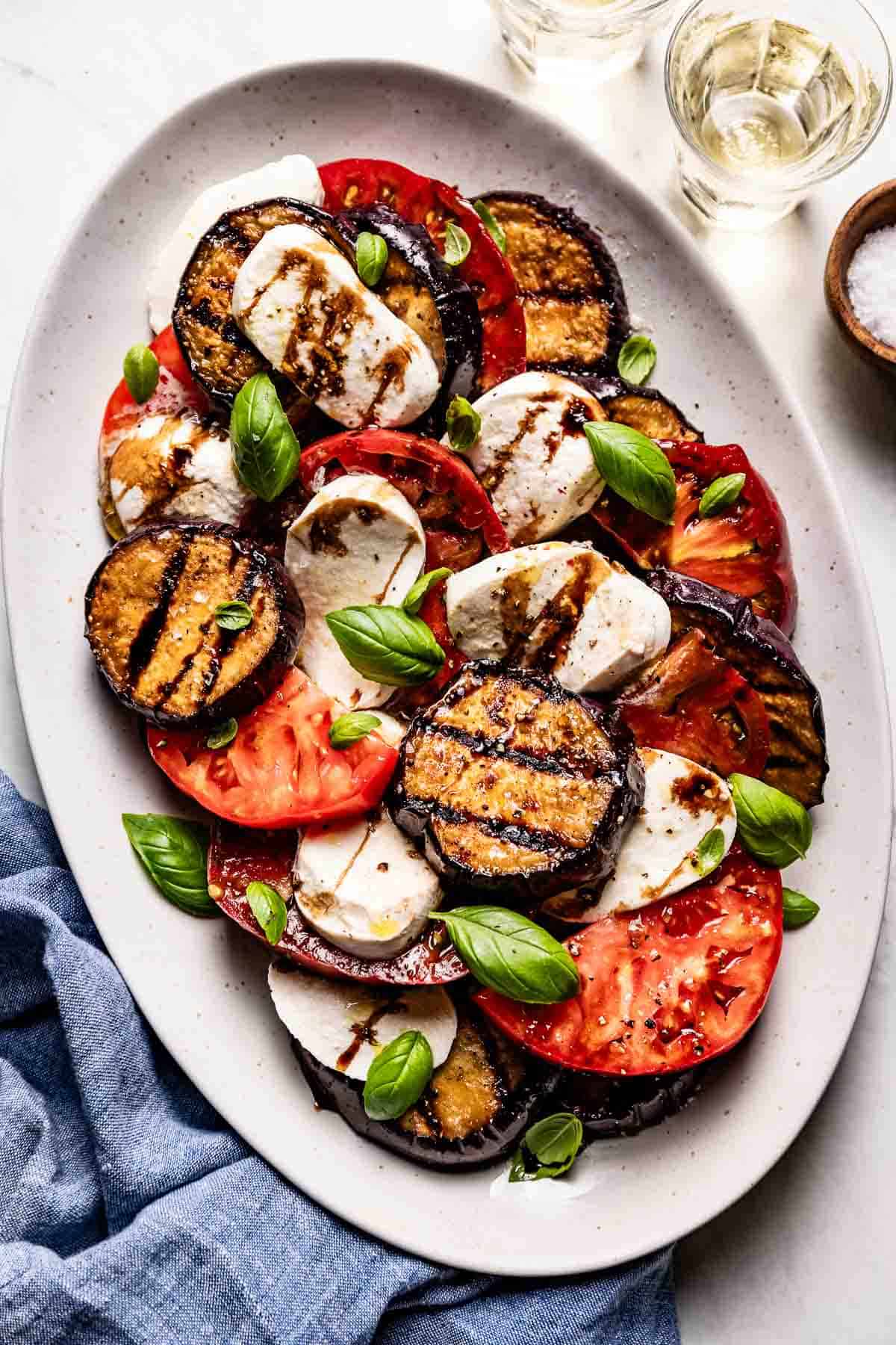 Eggplant caprese salad on a plate from the top view.