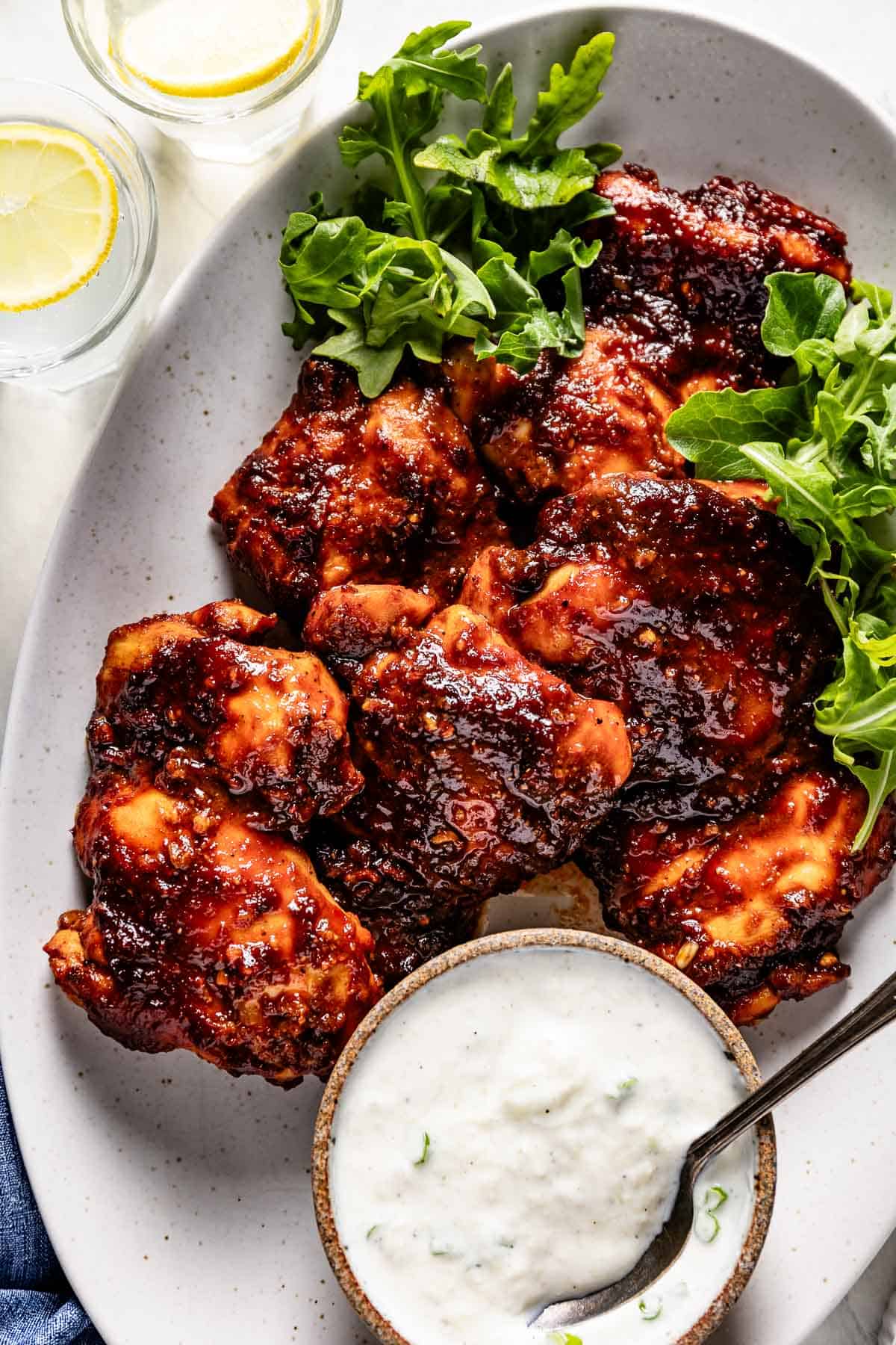 Freshly cooked harissa paste and chicken on a plate from the top view.