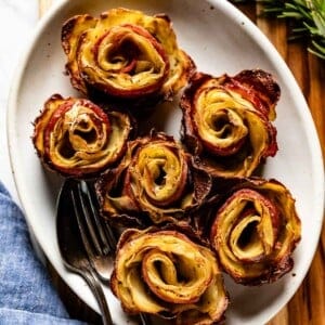 Bacon wrapped potatoes on a plate.