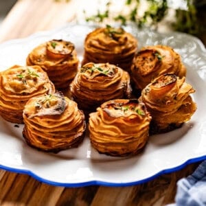 Sweet potatoes cooked in a muffin tin on a plate.