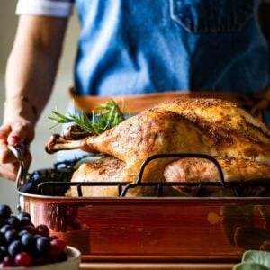 Thanksgiving herb turkey served by a person.