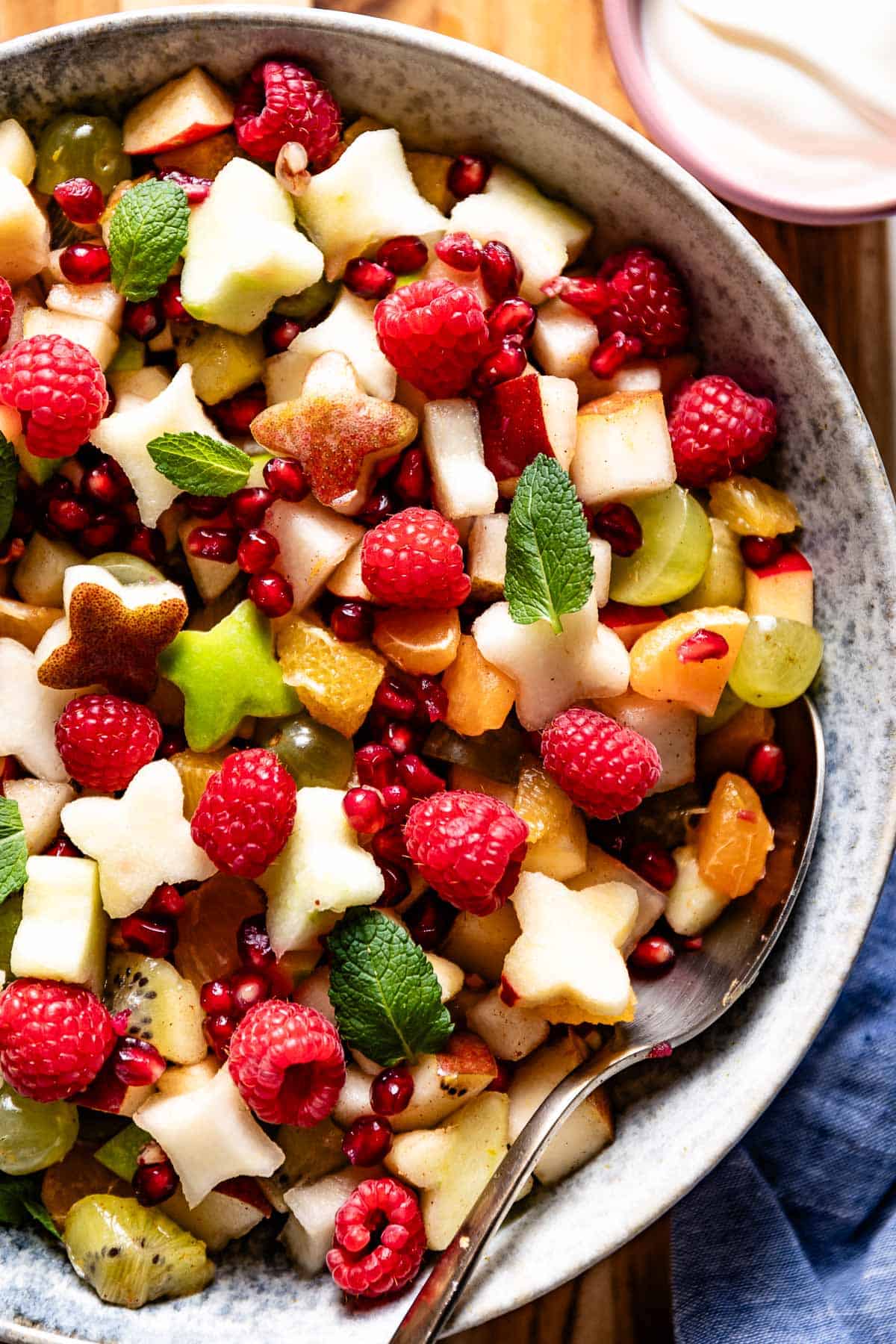 Christmas salad with fruit in a bowl from the top view.