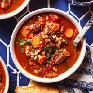 Beef and barley soup in a bowl from the top view.