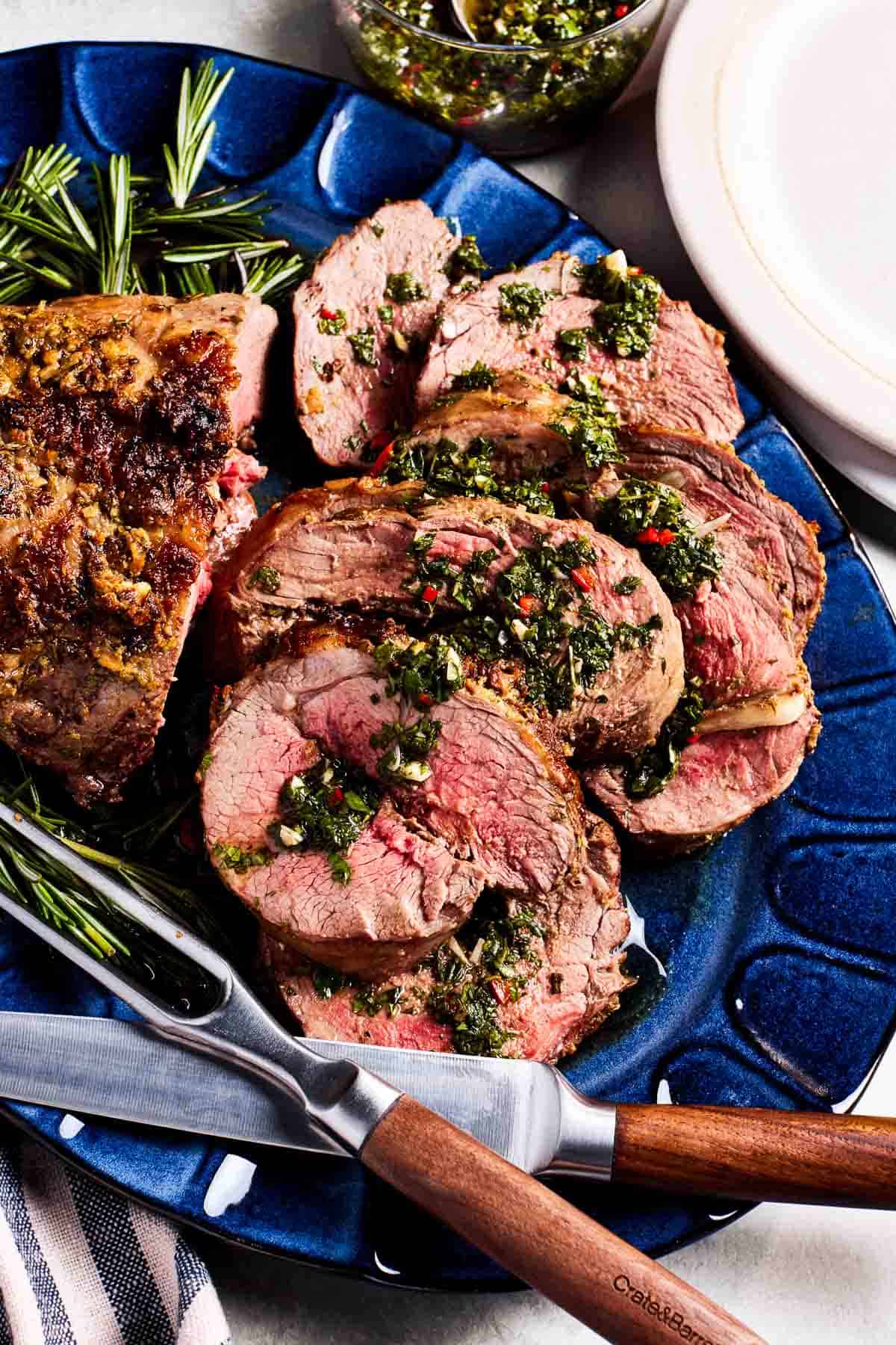 Sliced roasted boneless leg of lamb served with mint chimichurri. 