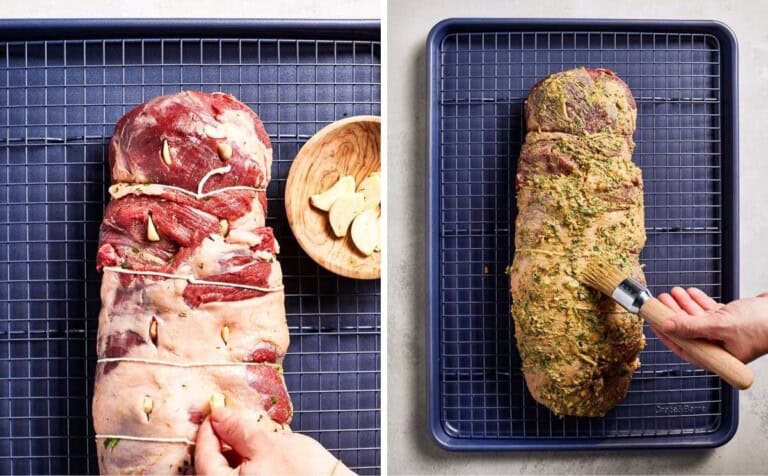 Person inserting garlic into the meat and spreading it with the rest of the seasoning.