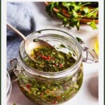 Garlic mint sauce in a jar with a spoonful.