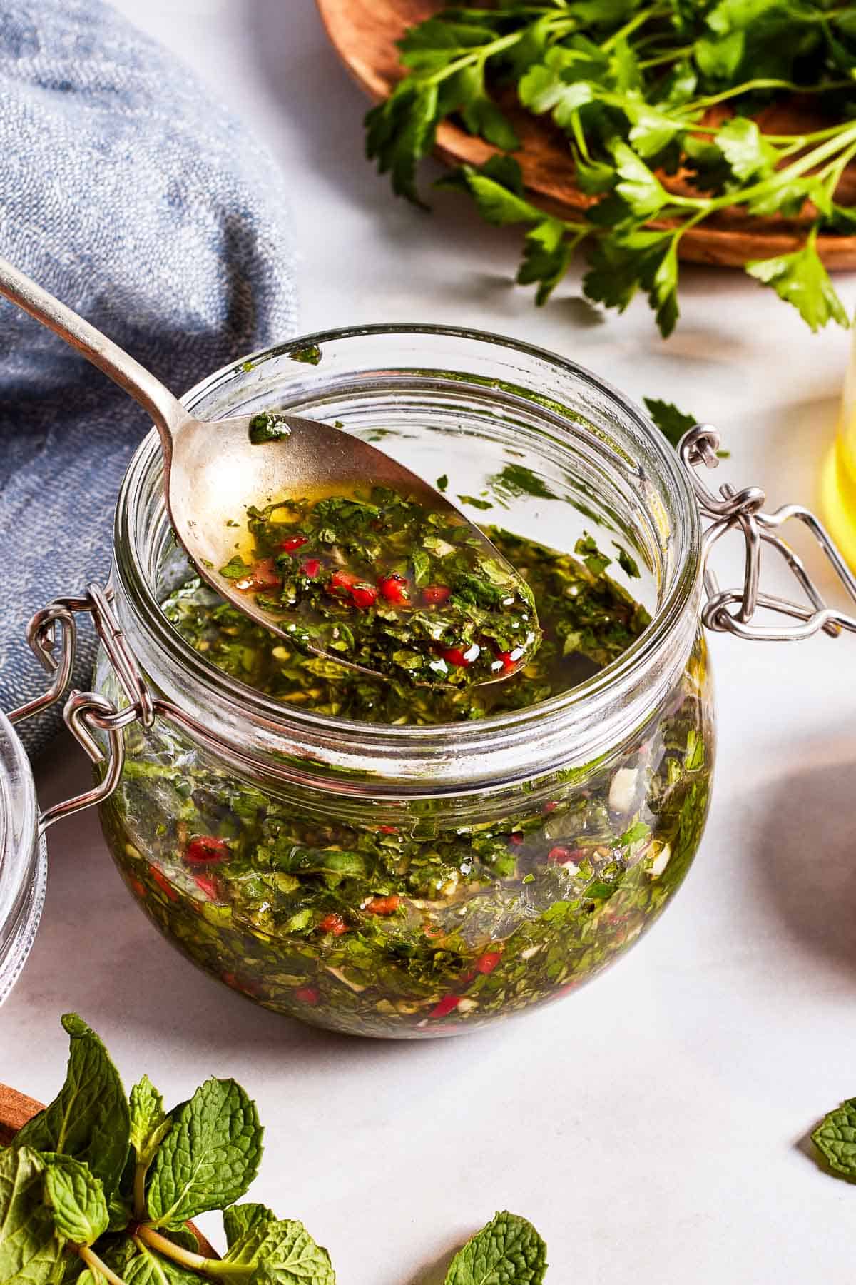 Mint chimichurri in a jar with a spoonful of it.