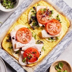 Cottage cheese flatbread topped off with deli meat, tomatoes and microgreens.