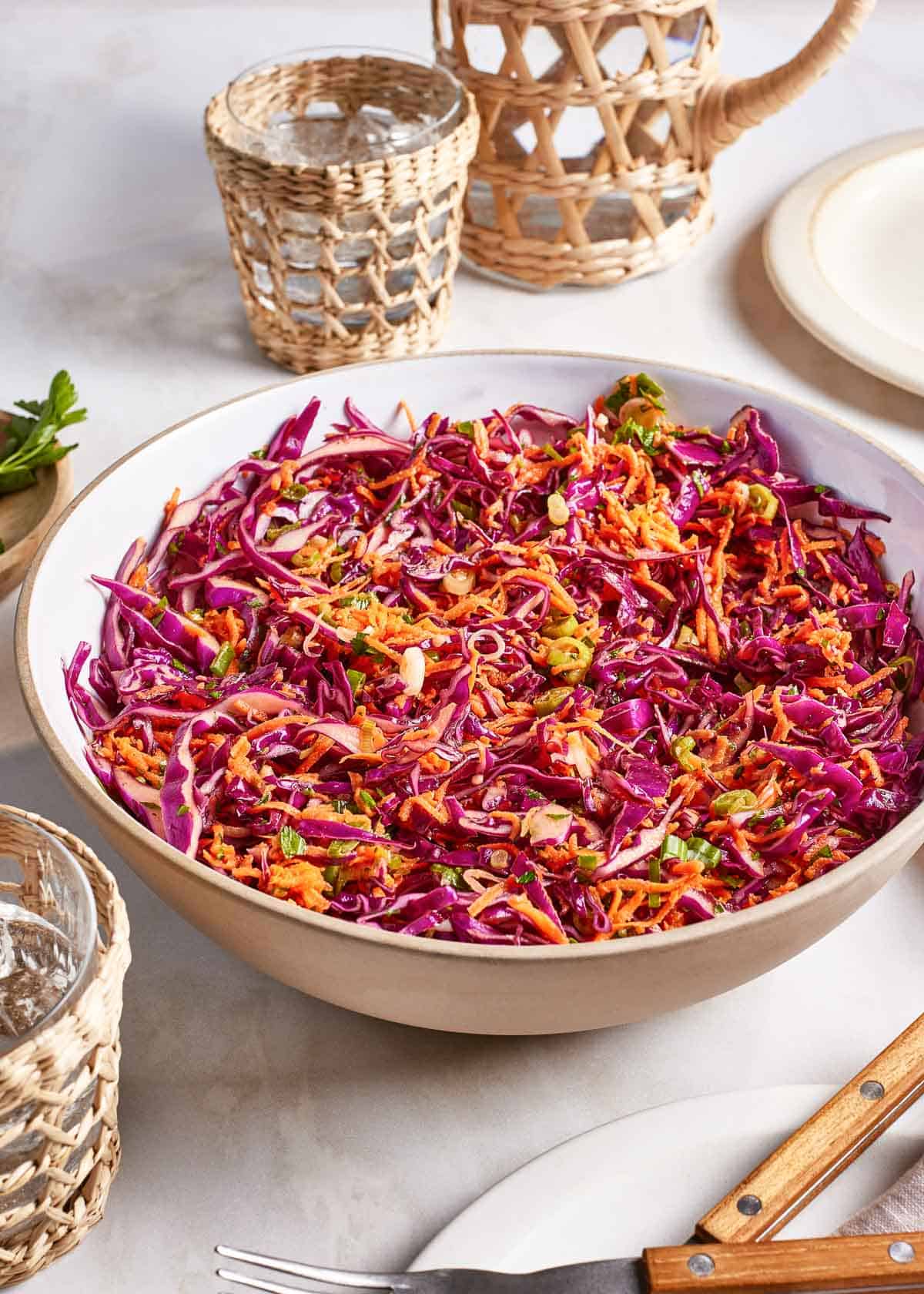 Coleslaw with red cabbage and carrots in a bowl.