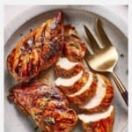 Balsamic marinated chicken sliced on a plate.