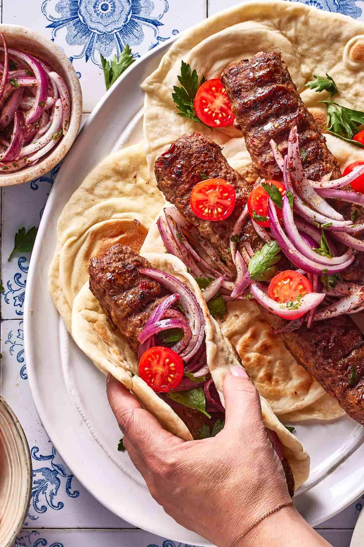 Adana wrap on a plate from the top view.