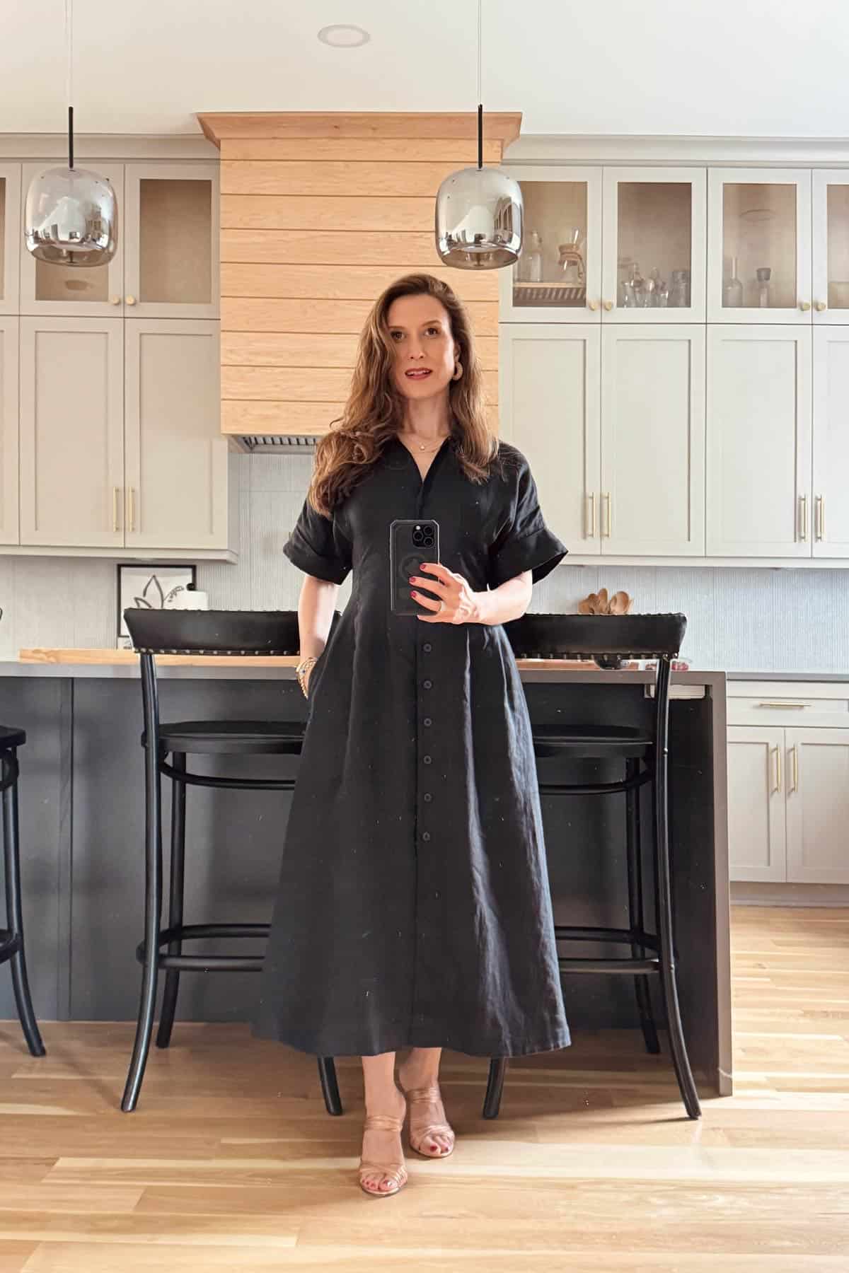 Photos of Aysegul wearing a black dress in the kitchen.
