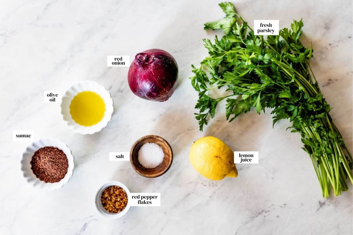 Ingredients for sumac red onions in bowls from the top view.