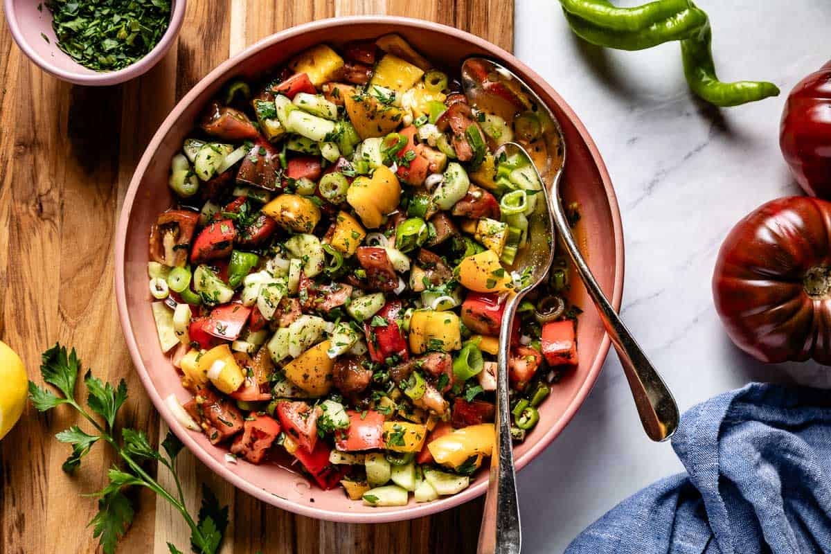 Shepherd salad in a bowl with spoons on the side.