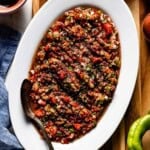 Spicy ezme served on an oval plate from the top view.