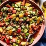 Turkish shepherd salad in a bowl with a spoon on the side.