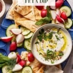 Whipped feta dip in a bowl with veggies around it.