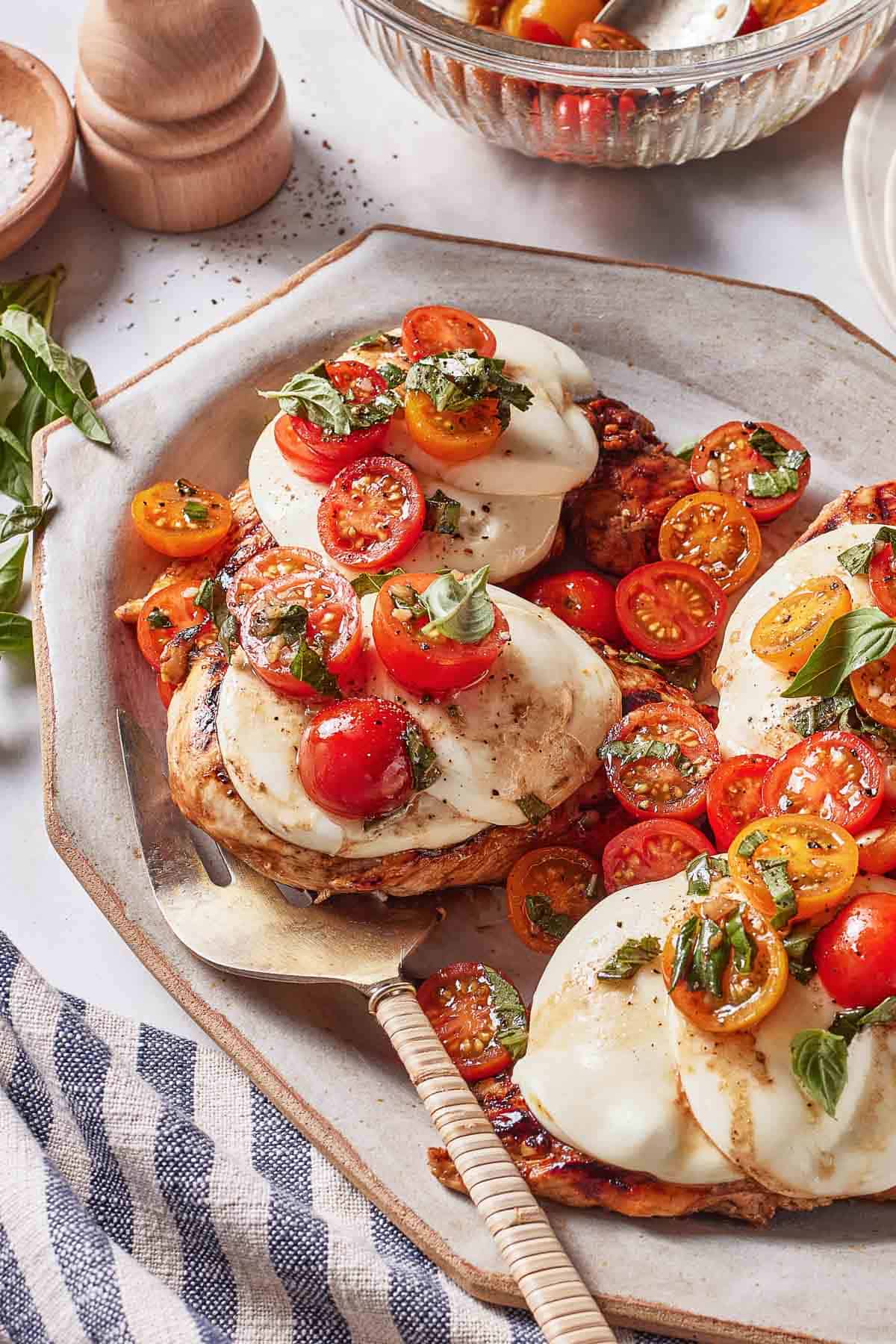 Grilled chicken Caprese style on a plate.