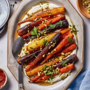 Harissa roasted carrots garnished with pistachios and parsley.