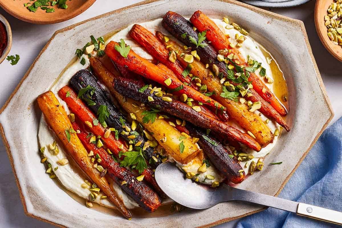 Harissa roasted carrots garnished with pistachios and drizzled with honey.