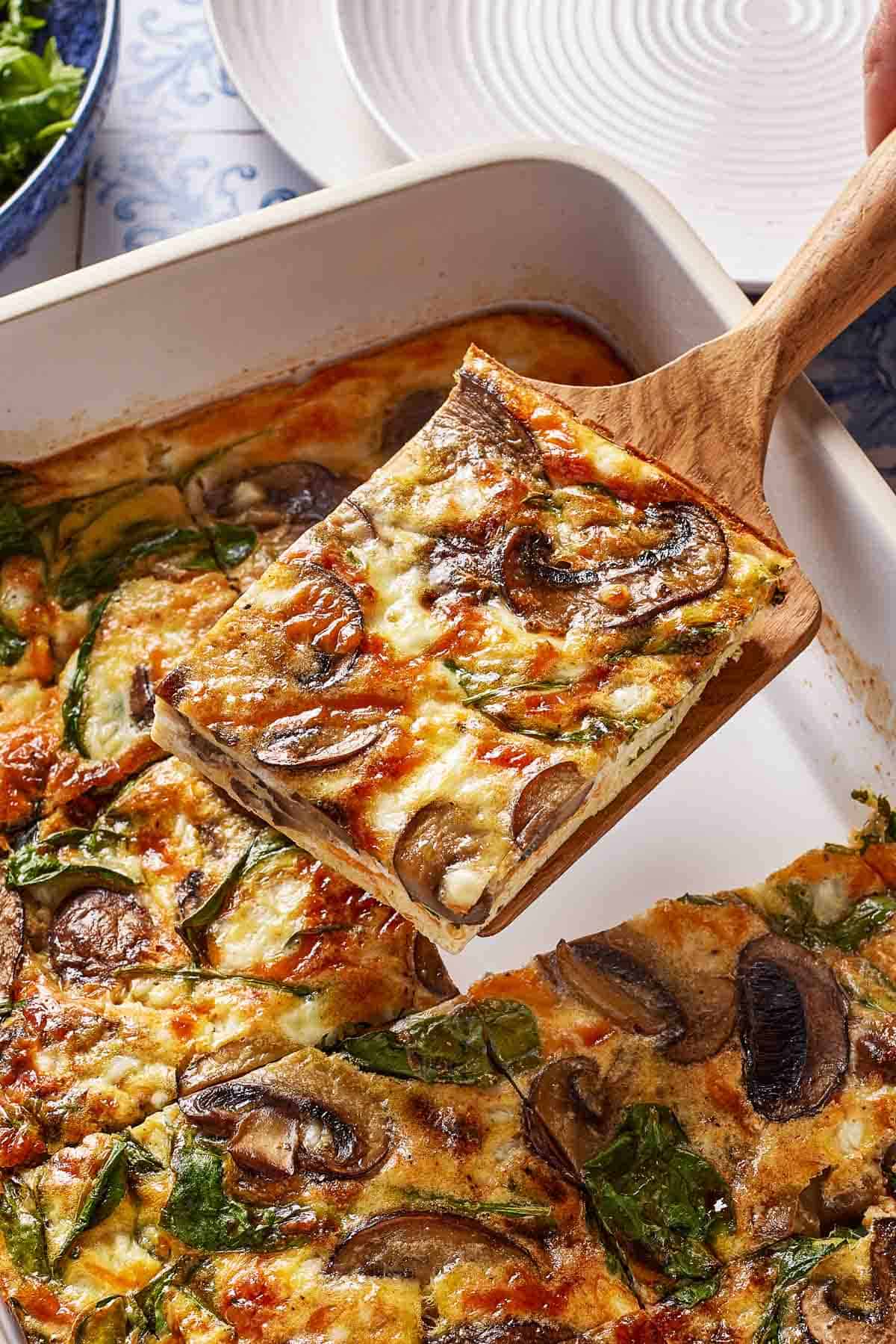 A slice of cottage cheese and egg bake on a spatula.
