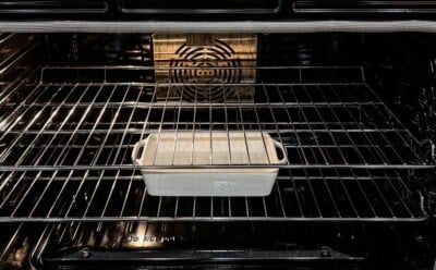 A casserole dish filled with water in the oven.