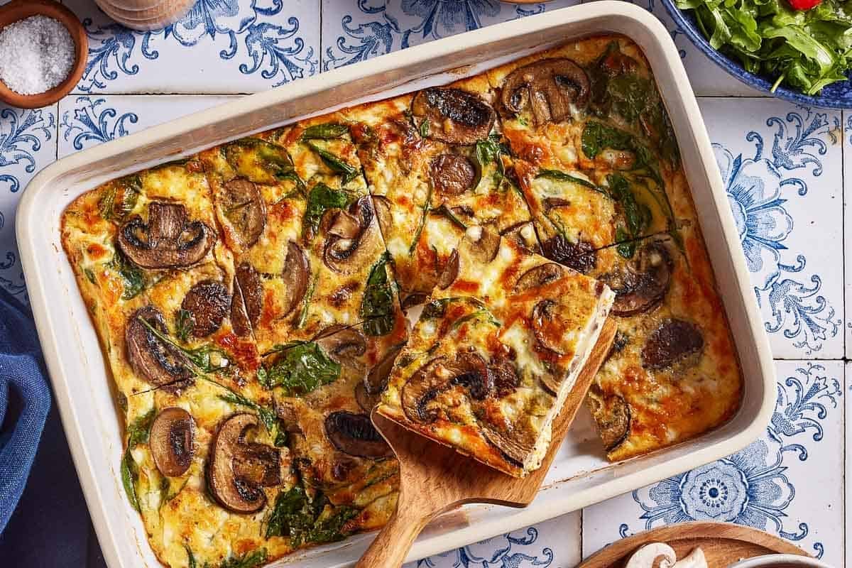 Baked eggs with cottage cheese in a casserole dish from the top view.