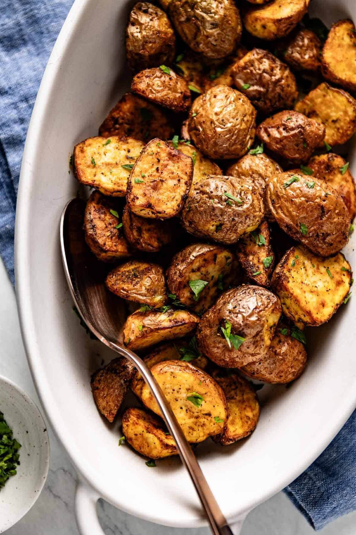 Crispy air fried red potatoes in a casserole dish.