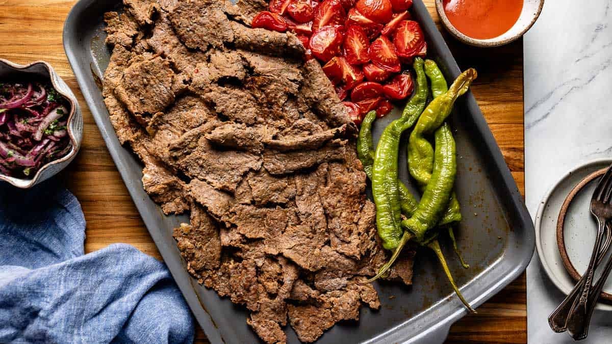 Viral Turkish doner recipe served with sumac onions and tomato sauce from the top view.