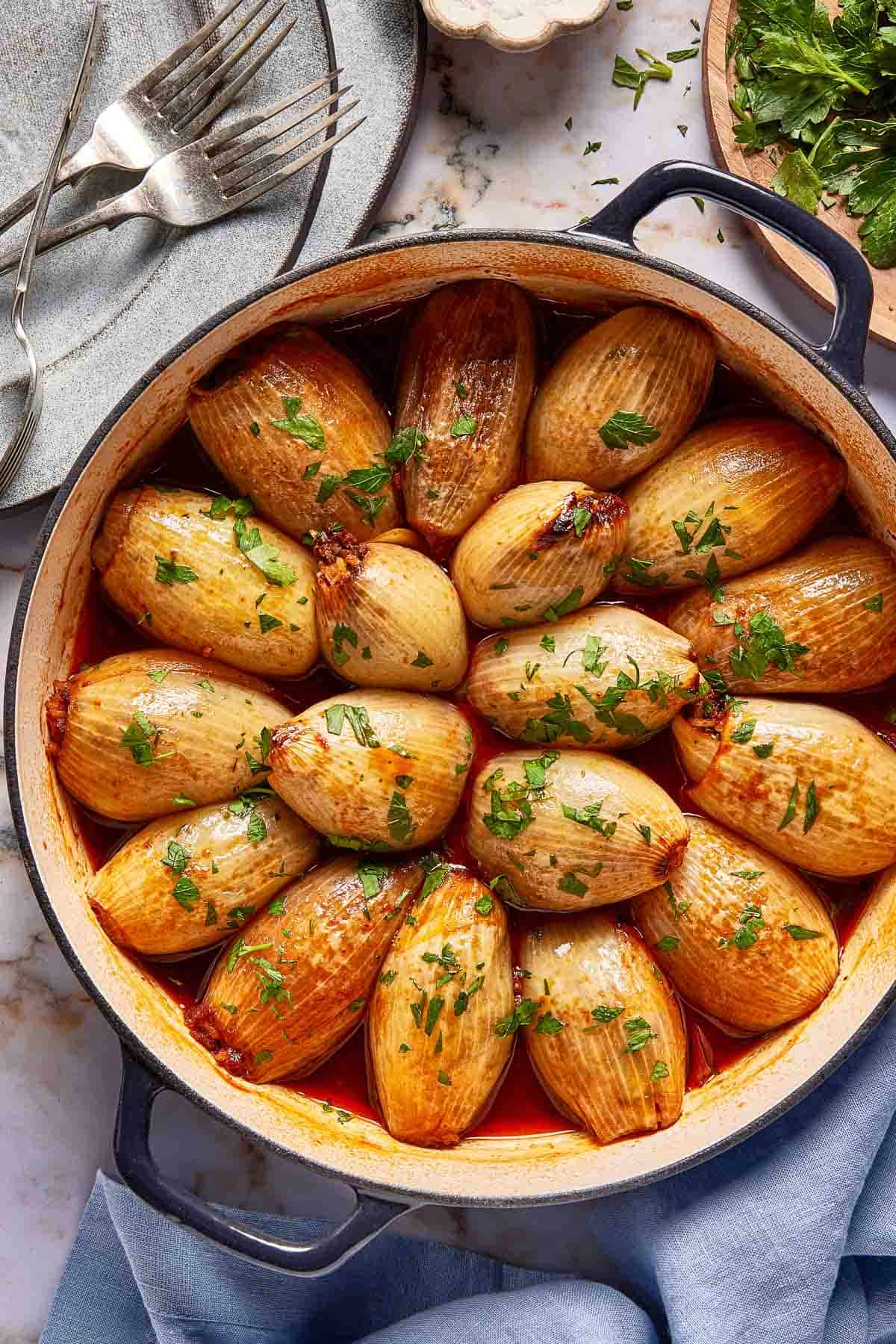 Stuffed onions in a skillet from the top view.