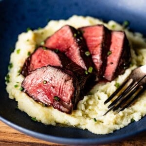 Filet mignon on a bed of mashed potatoes as a date night dinner idea.