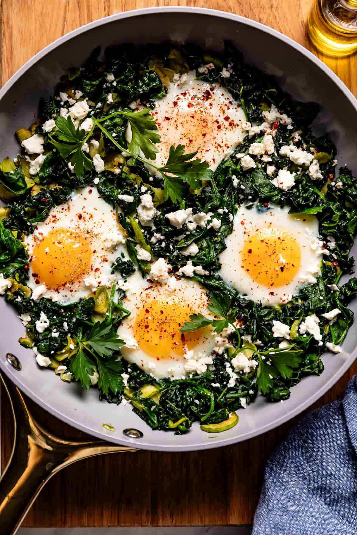 Green shakshuka garnished with Aleppo pepper and feta cheese.
