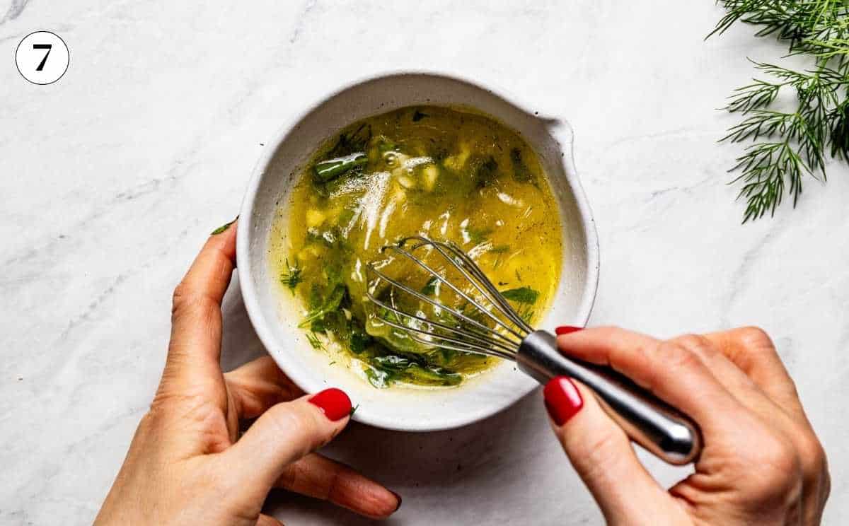 Whisking lemon olive oil herb sauce to serve with whole roasted branzino.
