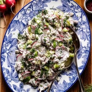 A close-up square shot of the final chicken salad with yogurt dressing, feta cheese, and fresh herbs, perfect for a Mediterranean lunch.