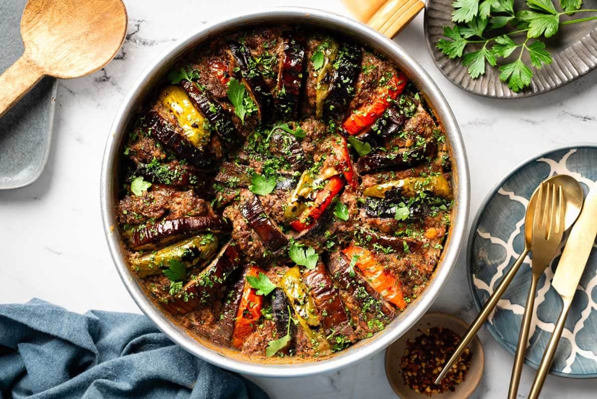 Freshly baked eggplant kebab garnished with parsley from the top view.