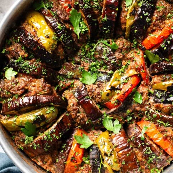 Baked eggplant kebab fresh out of the oven from the top view garnished with parsley.